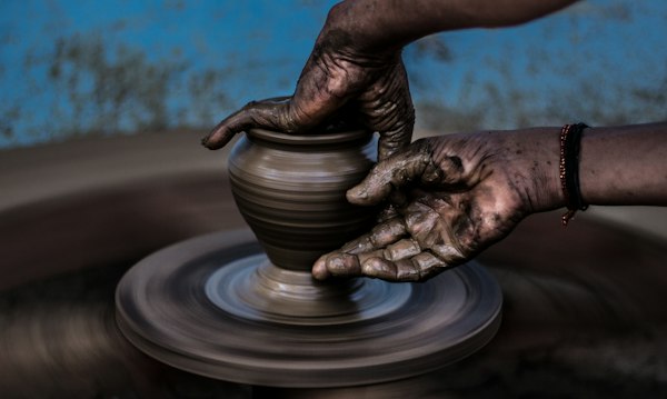 Potter shaping a bowl on the wheel